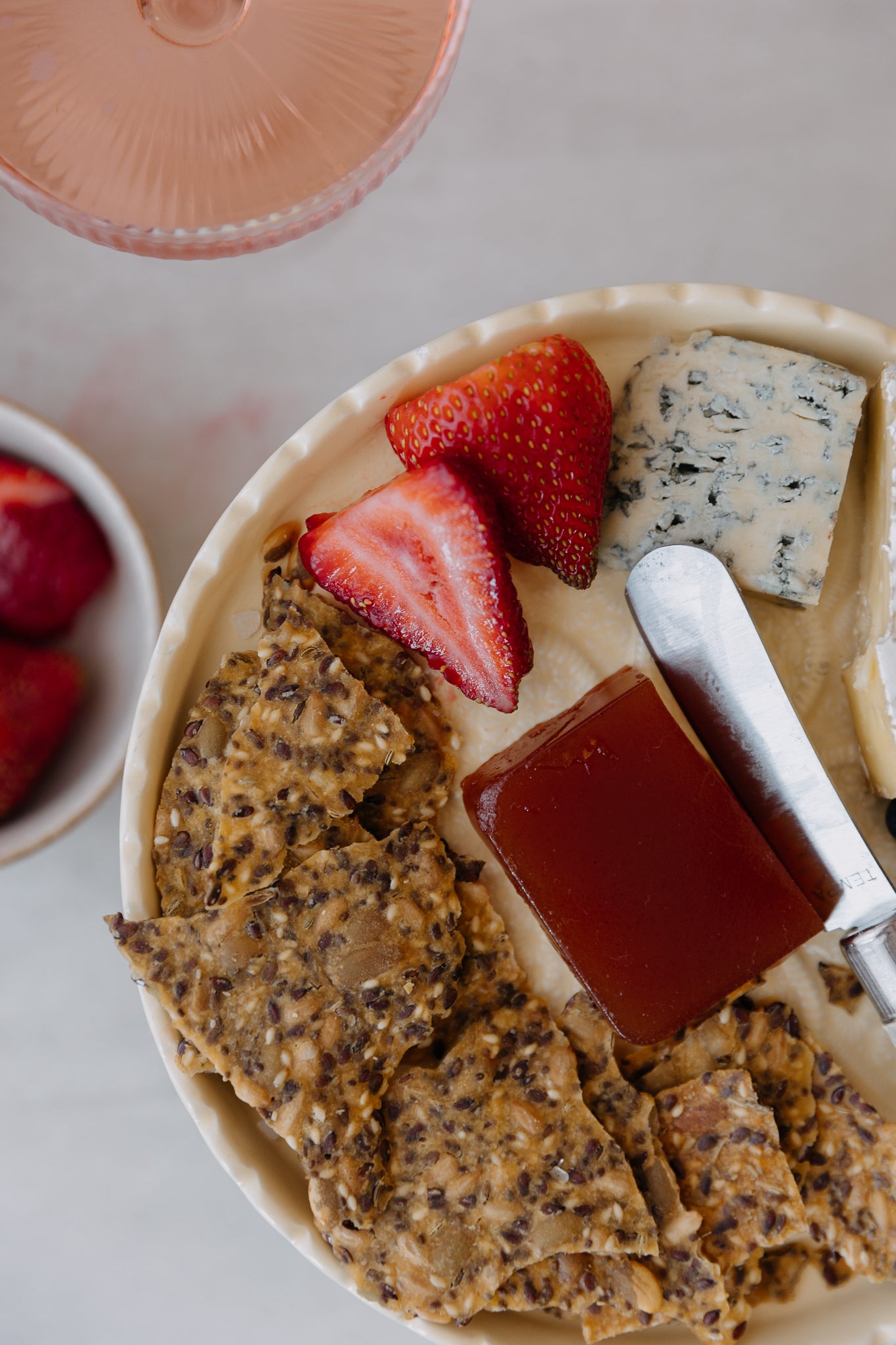 Freshly baked Kiki crackers served on a platter with dips, cheese and toppings.